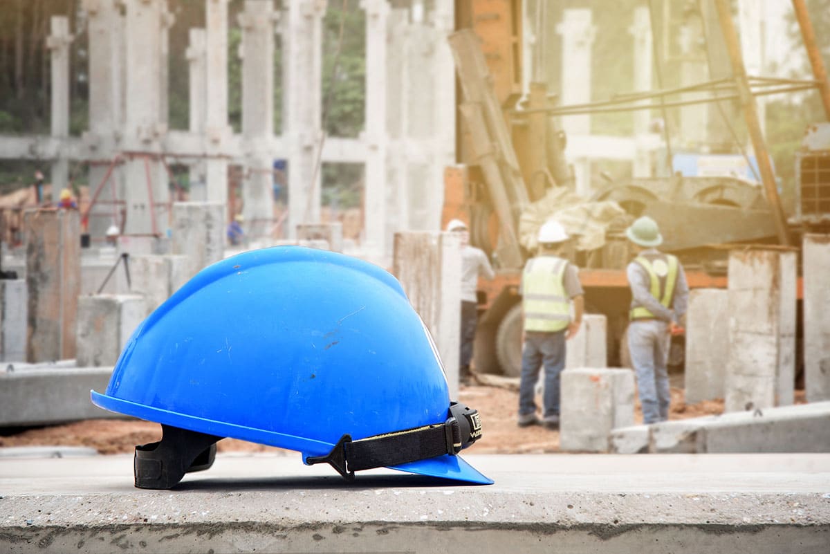 Blue hard helmet on ledge of construction site