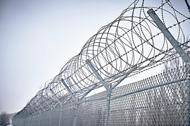 Prison fence with barbed wire