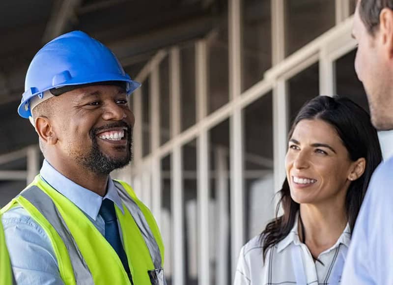 Construction worker talking to customers