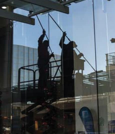 Man washing windows of a building